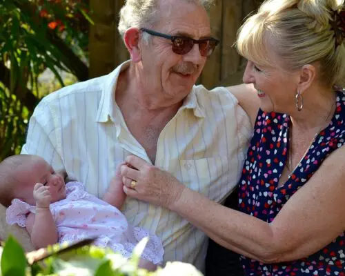 grandparents holding grandchild