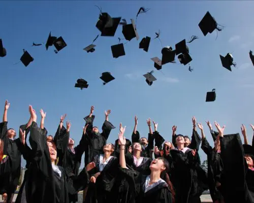 graduating students throwing caps