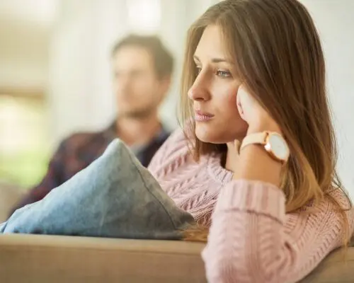 divorced couple sitting on couch