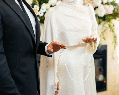Close-up of a bride and groom holding a decorative wedding cord during a marriage ceremony. Image represents inheritance and estate planning challenges in second or third marriages under Pennsylvania law, including blended family estate rights.